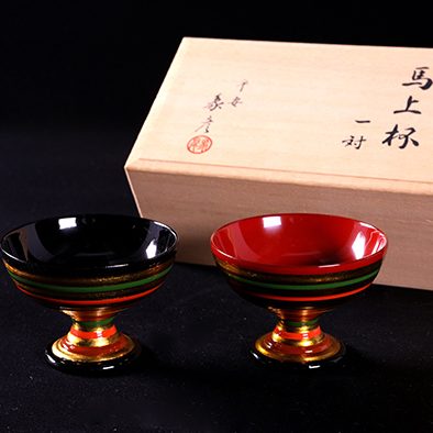 The lacquered Sake cup set and special wooden box.